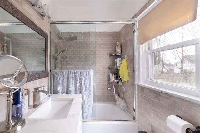 bathroom with combined bath / shower with glass door and vanity