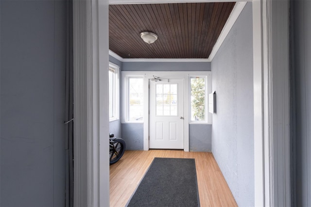 doorway featuring a textured wall, wood ceiling, crown molding, and wood finished floors