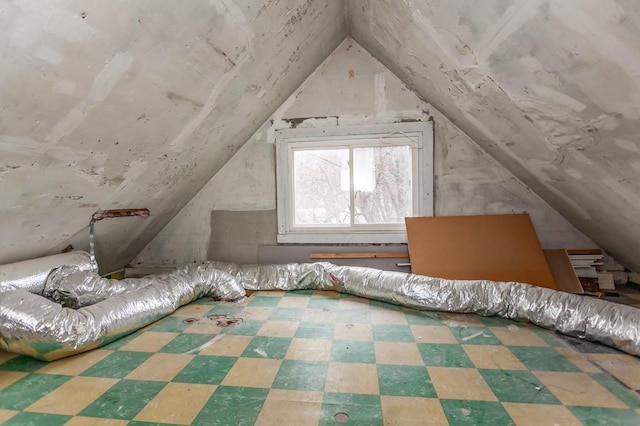 additional living space featuring lofted ceiling and tile patterned floors