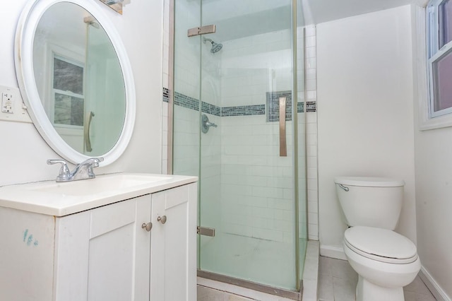 full bathroom with tile patterned flooring, toilet, vanity, baseboards, and a shower stall