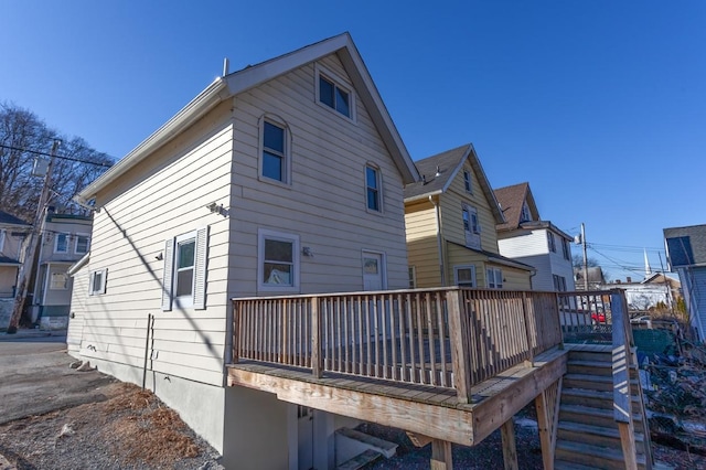 rear view of property with a wooden deck