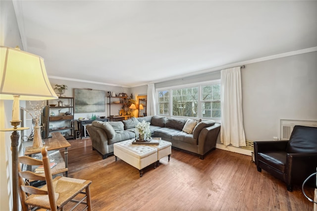 living area with crown molding and wood finished floors