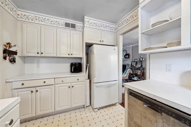 kitchen with light floors, open shelves, light countertops, freestanding refrigerator, and dishwasher