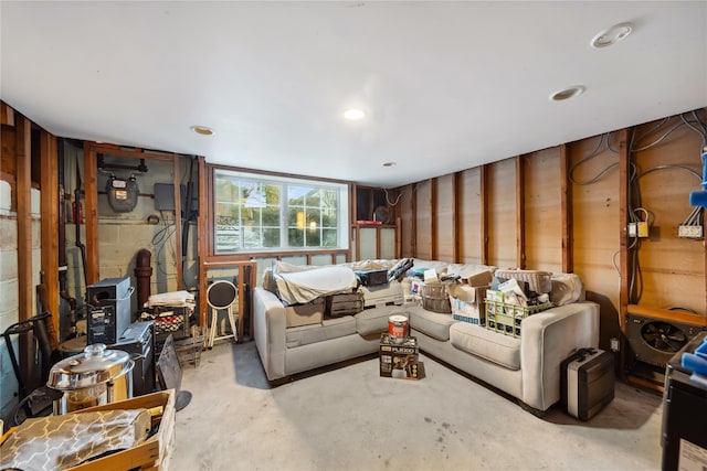 living room with concrete block wall and concrete floors