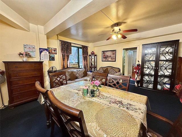 dining area featuring dark carpet and ceiling fan