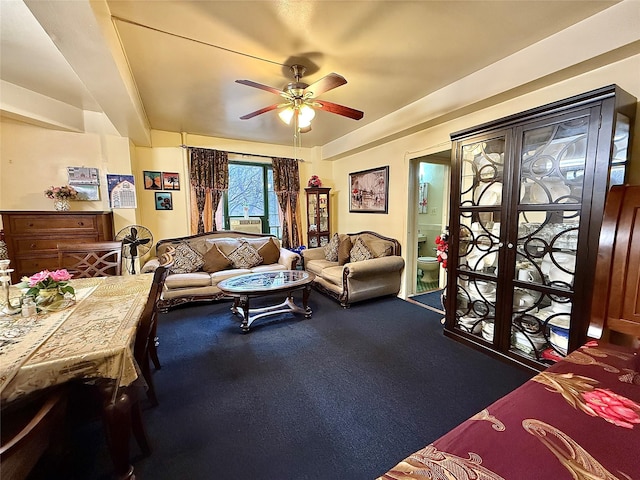 living area with carpet and ceiling fan