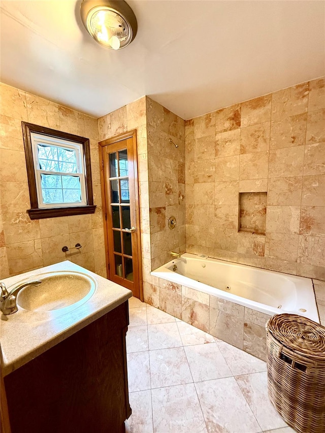 bathroom with tiled shower / bath combo, tile walls, vanity, and tile patterned flooring