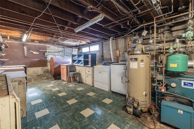 below grade area featuring washing machine and dryer, water heater, a heating unit, and tile patterned floors