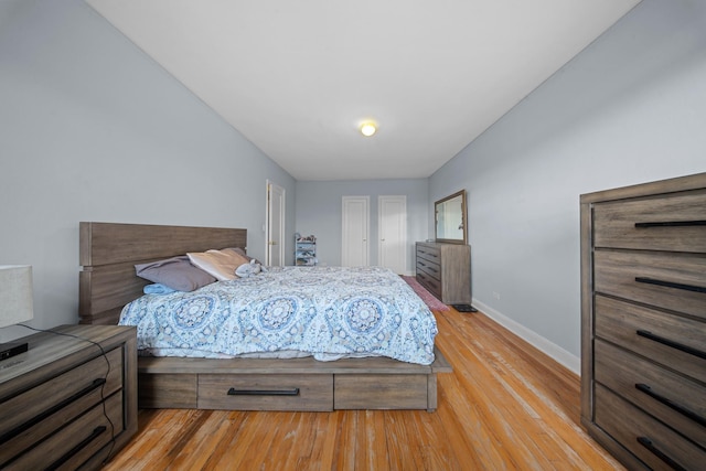 bedroom featuring light wood-type flooring and baseboards