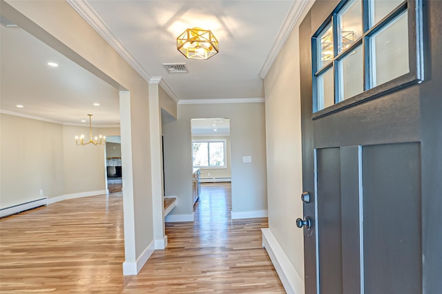 entryway with crown molding, visible vents, a baseboard heating unit, light wood-type flooring, and baseboards