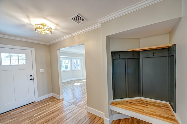 mudroom with light wood-style floors, visible vents, ornamental molding, and baseboards