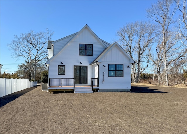 back of property featuring fence, board and batten siding, and a wooden deck