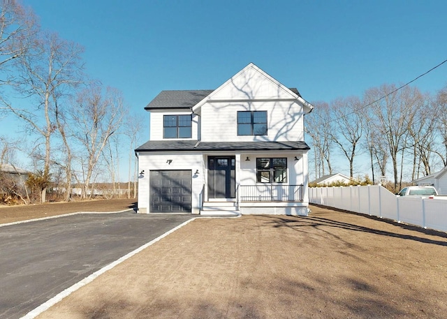 view of front of property with aphalt driveway, fence, roof with shingles, covered porch, and an attached garage