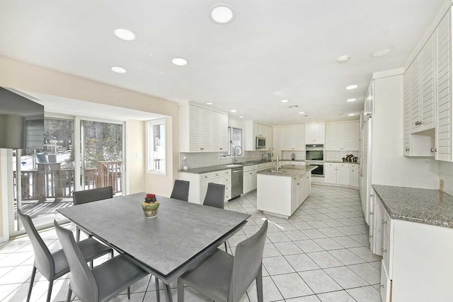 dining space with recessed lighting and light tile patterned floors