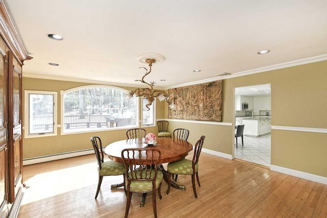 dining space featuring a baseboard radiator, recessed lighting, baseboards, light wood-style floors, and ornamental molding