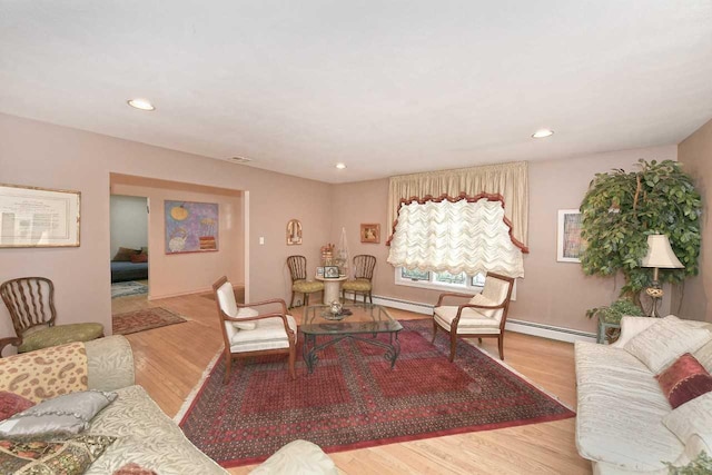 living room with recessed lighting, baseboard heating, and wood finished floors