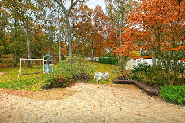 view of property's community featuring a playground and a yard