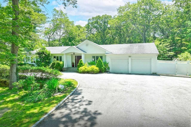 4 Hunting Hill Dr, Dix Hills, NY 11746 - ranch-style house featuring asphalt driveway, a garage, and a gate