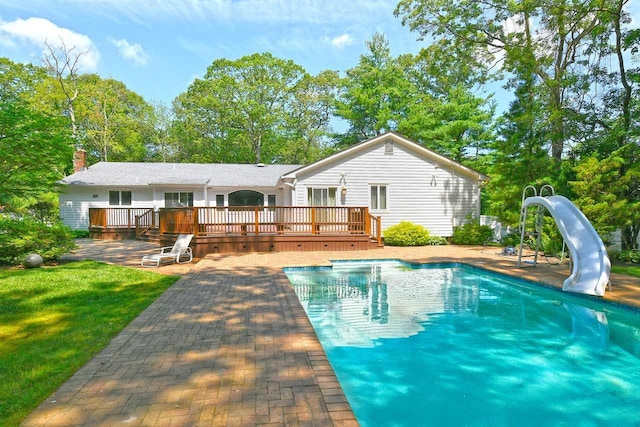 4 Hunting Hill Dr, Dix Hills, NY 11746 - back of house with a wooden deck, an outdoor pool, a patio, a yard, and a chimney