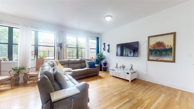 living room featuring light wood finished floors and baseboards