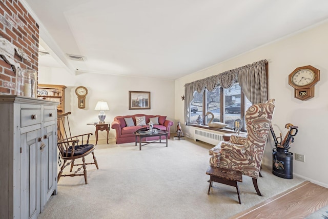 living room featuring radiator heating unit, carpet, visible vents, and baseboards