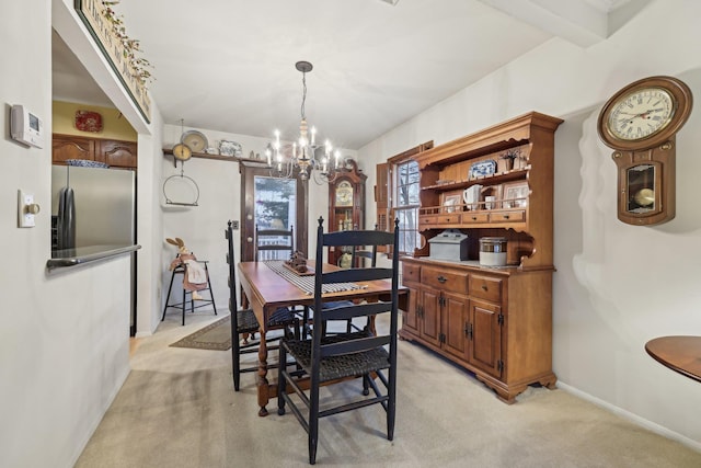 dining area featuring light carpet, baseboards, a chandelier, and beamed ceiling