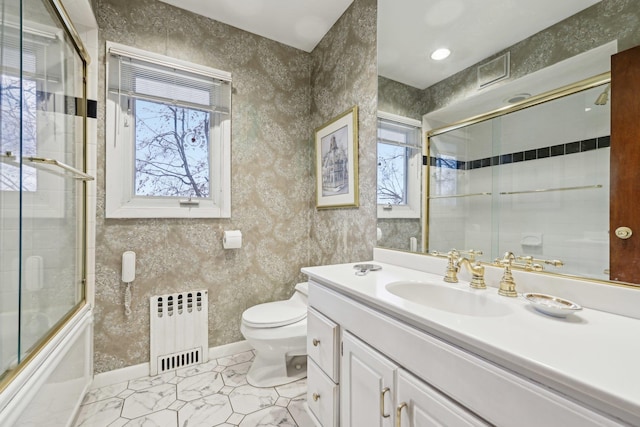 full bathroom with enclosed tub / shower combo, plenty of natural light, vanity, and radiator