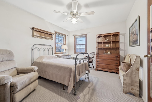 bedroom featuring light carpet and ceiling fan