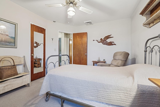 carpeted bedroom featuring ceiling fan and visible vents