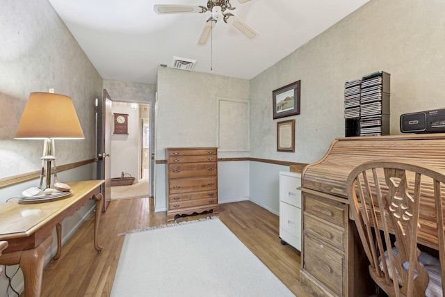 office with ceiling fan, light wood-type flooring, and visible vents