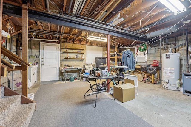 unfinished basement with concrete block wall and gas water heater