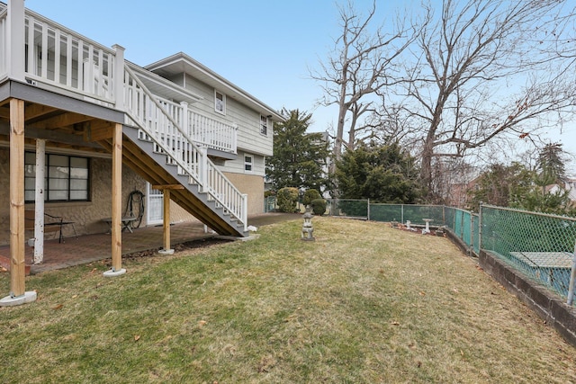 view of yard featuring stairway, a patio area, a wooden deck, and a fenced backyard