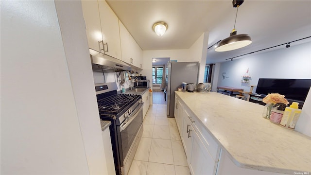 kitchen with pendant lighting, appliances with stainless steel finishes, white cabinets, and under cabinet range hood