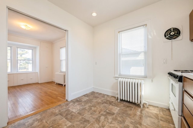 interior space with recessed lighting, visible vents, baseboards, radiator, and radiator heating unit