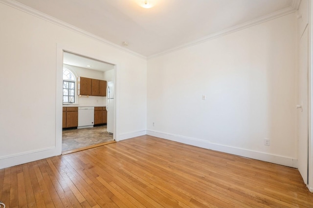 unfurnished living room with light wood-style floors, baseboards, and ornamental molding