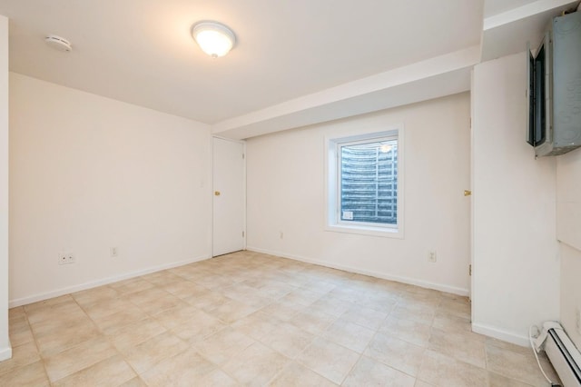 spare room with a baseboard radiator and baseboards