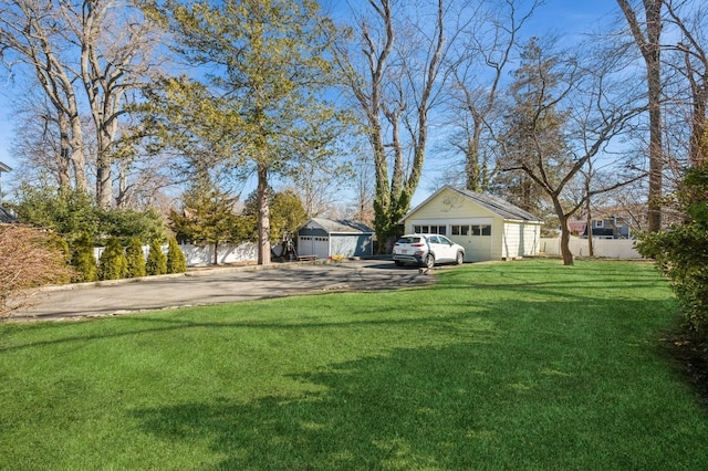 view of yard with a garage and fence