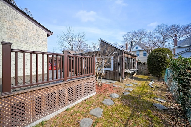 back of house featuring an outdoor structure, a fenced backyard, and a wooden deck