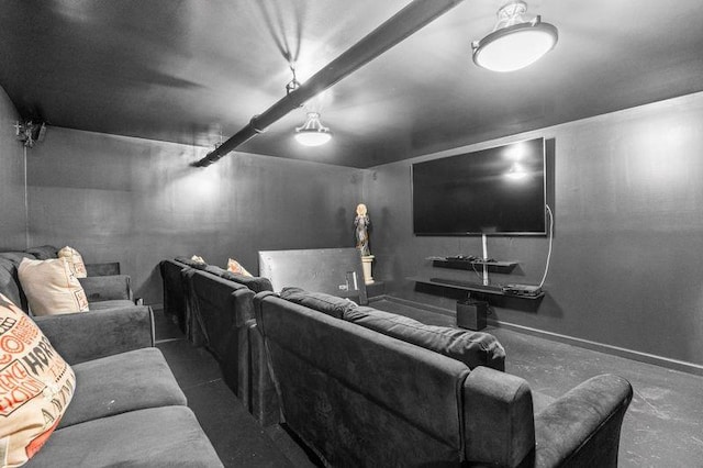 cinema room featuring beam ceiling