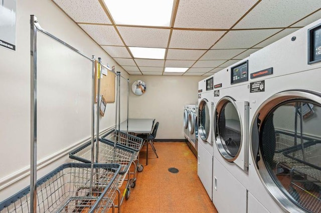 common laundry area with washing machine and clothes dryer and tile patterned floors