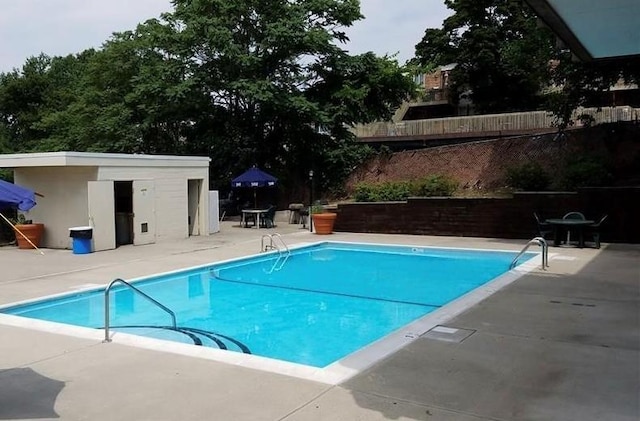 community pool featuring a patio area and fence