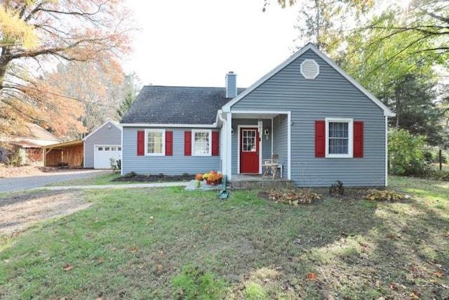 view of front facade featuring driveway, a front lawn, a chimney, and roof with shingles