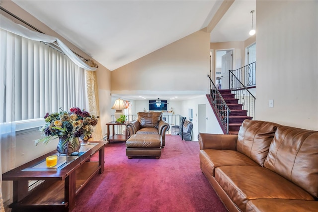 carpeted living area with high vaulted ceiling and stairway