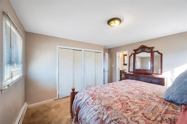 bedroom featuring a baseboard heating unit, baseboards, light colored carpet, and multiple closets