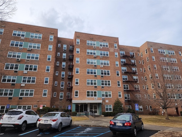 view of building exterior with uncovered parking