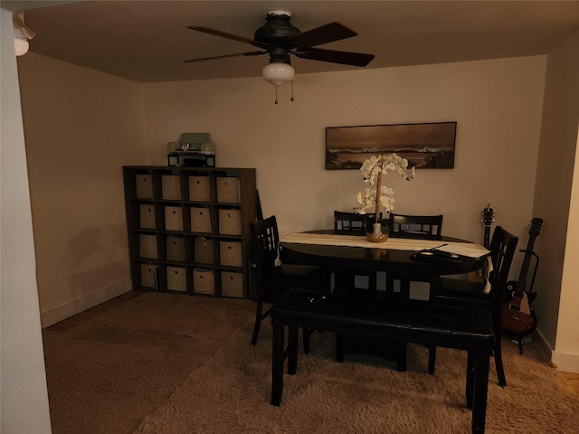 dining area with a ceiling fan, carpet flooring, and baseboards