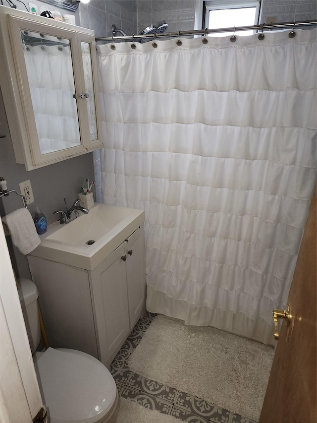 bathroom featuring toilet, a shower with curtain, and vanity