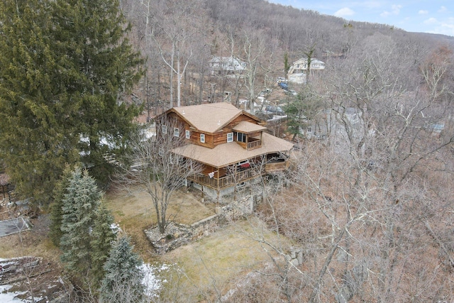 birds eye view of property featuring a view of trees