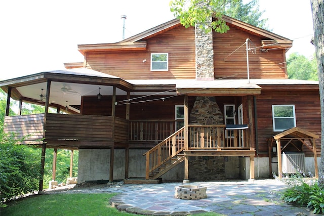 back of house with an outdoor fire pit, stairs, and cooling unit