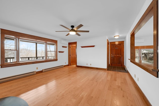 unfurnished living room featuring an AC wall unit, baseboards, light wood-style flooring, and baseboard heating